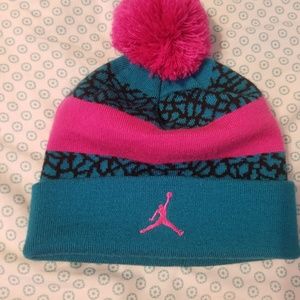 A girl's Jordan beanie and a Red Raiders beanie